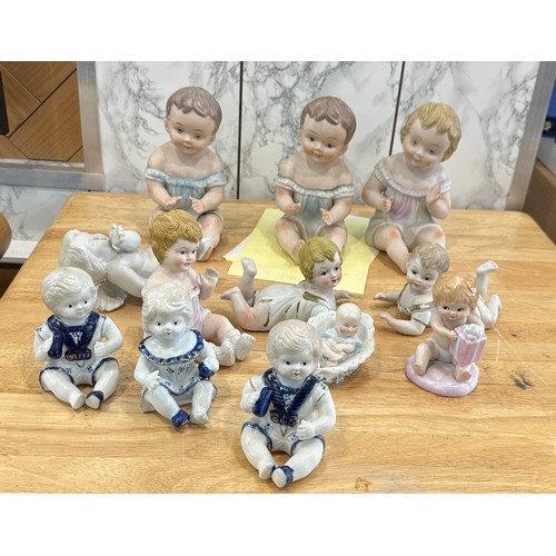 376 - Large selection of assorted Baby figures includes Piano babies etc