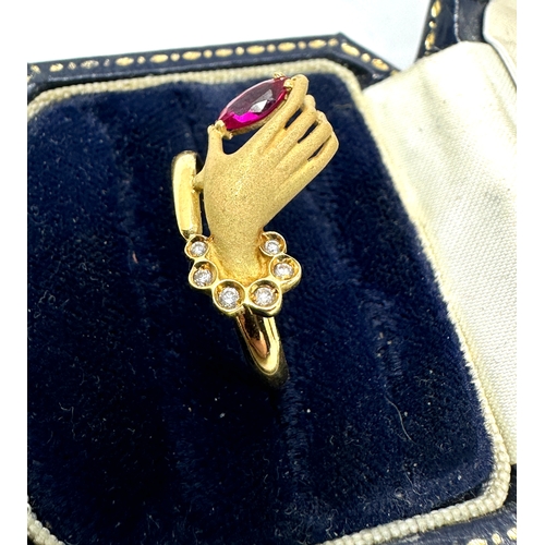 104 - 18ct gold hand ring set with red & white gemstones weight 2.9g has been xrt tested as 18ct gold