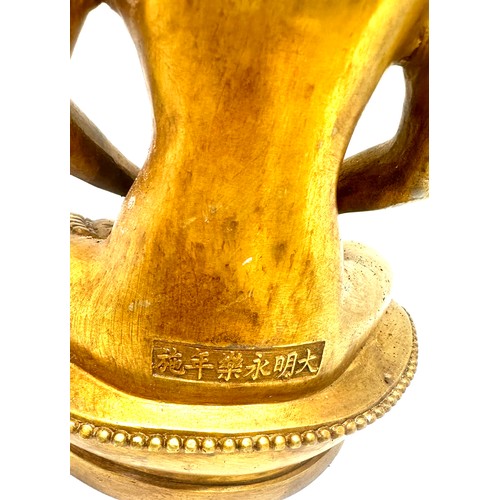 575 - Brass Buddha oriental figure, marks to base height approximately 11 inches tall