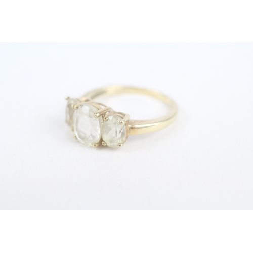 252 - 9ct gold white spodumene three stone ring