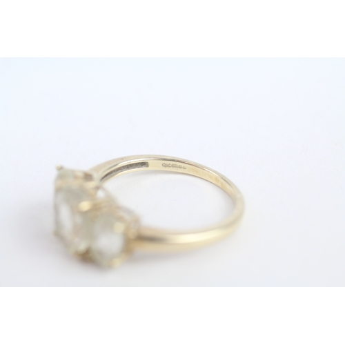 252 - 9ct gold white spodumene three stone ring