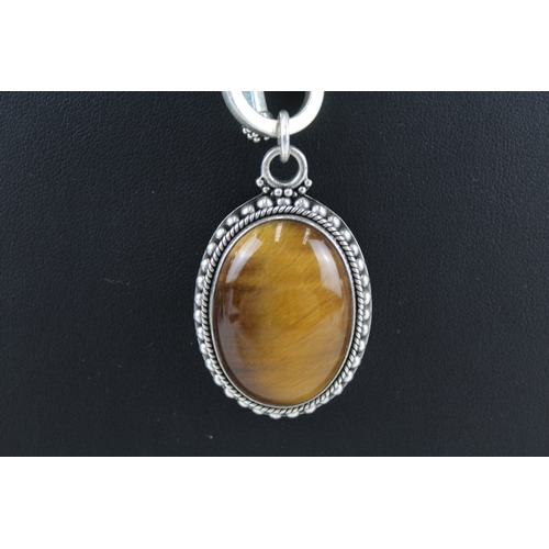 305 - A silver tigerseye pendant necklace by Suarti (51g)