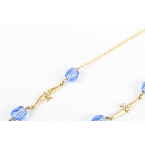 255 - 9ct gold faceted blue glass & flying birds necklace