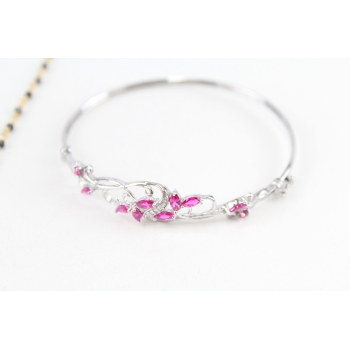 308 - A silver necklace and bangle, set with diamonds, ruby and sapphire (16g)