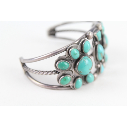 312 - A silver Native American turquoise set bangle (60g)