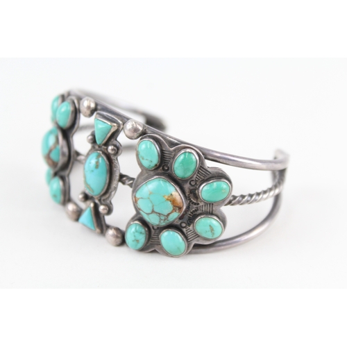 312 - A silver Native American turquoise set bangle (60g)