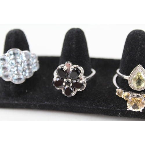 316 - Eight silver stone set rings including topaz and diamond (28g)