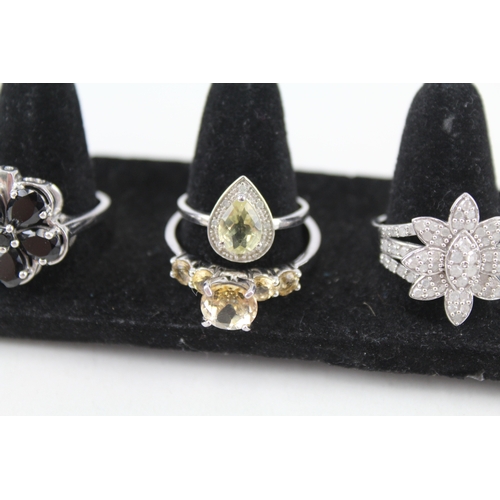 316 - Eight silver stone set rings including topaz and diamond (28g)