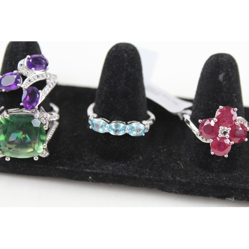 324 - Eight silver stone set rings including ttanzanite and ruby (40g)