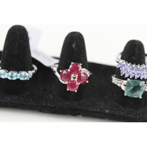 324 - Eight silver stone set rings including ttanzanite and ruby (40g)