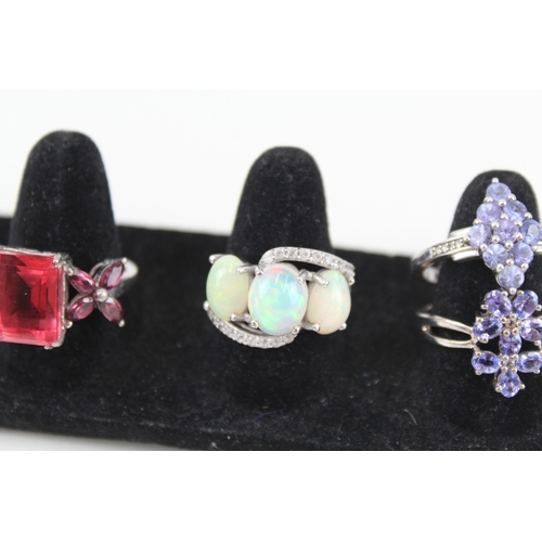 326 - Eight silver stone set rings including tanzanite and opal (33g)