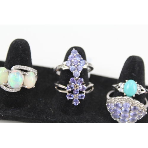 326 - Eight silver stone set rings including tanzanite and opal (33g)