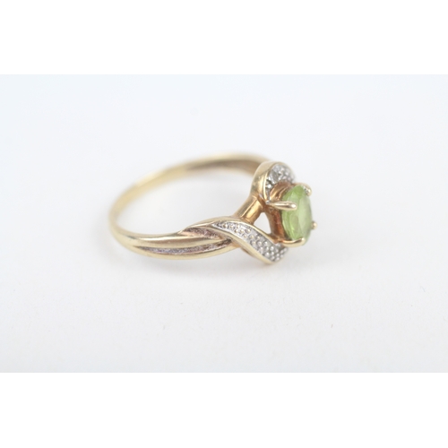 211 - 9ct gold peridot single stone ring with diamond frame