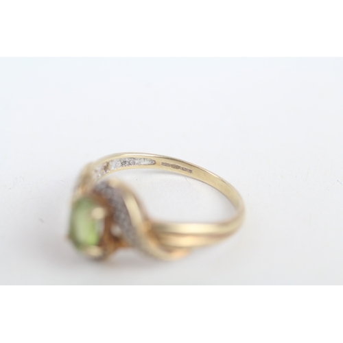 211 - 9ct gold peridot single stone ring with diamond frame