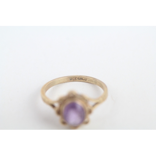 217 - 9ct gold oval cut amethyst single stone ring with wavy openwork frame