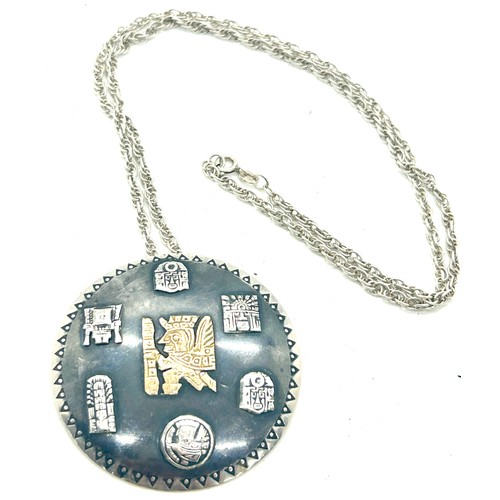 515 - Silver Inca design medallion pendant with a 18k gold Inca insert symbol on a silver chain, diameter ... 