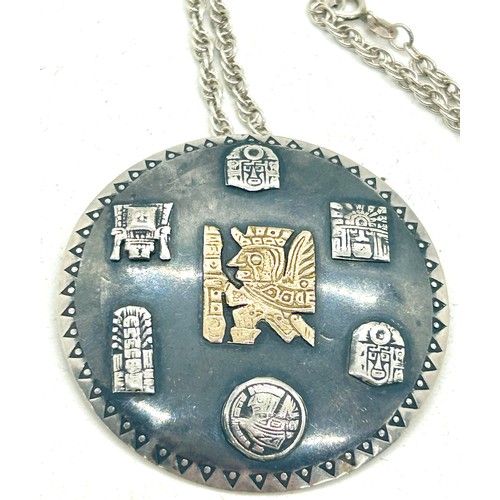 515 - Silver Inca design medallion pendant with a 18k gold Inca insert symbol on a silver chain, diameter ... 