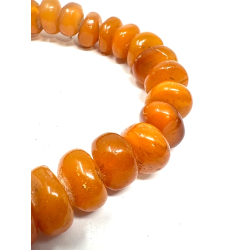 97 - Egg yolk amber bead necklace weight 65g