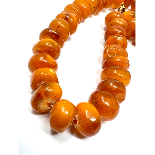 97 - Egg yolk amber bead necklace weight 65g