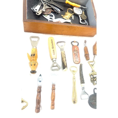 33 - Large selection of vintage Novelty bottle openers in a display case/ drawer