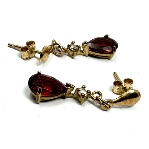 124 - 9ct gold garnet earrings weight 1.2g