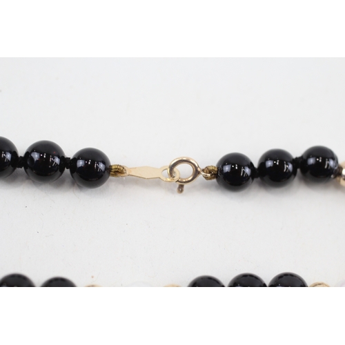 231 - 9ct gold pearl & black gemstone bracelet (6.8g)