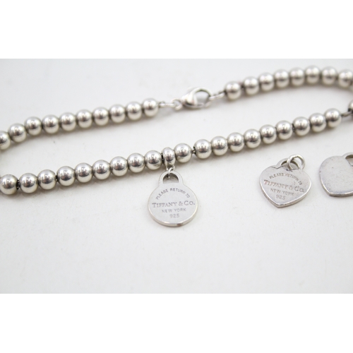 330 - Silver bracelet and pendants/charms by designer Tiffany & Co (7g)