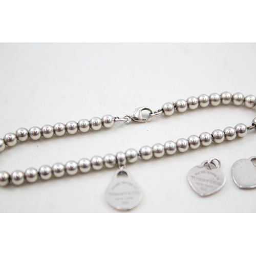 330 - Silver bracelet and pendants/charms by designer Tiffany & Co (7g)