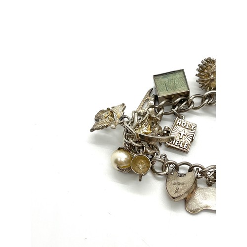 611 - Silver charm bracelet, 70 grams