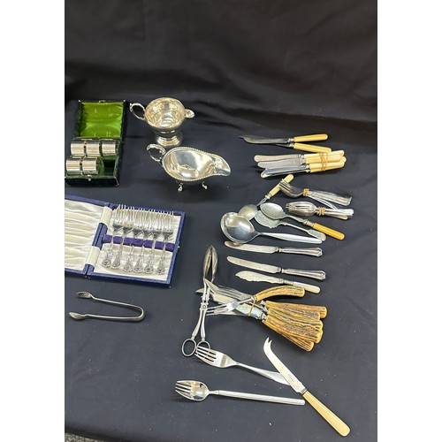 572 - Selection of silver plated items to include napkin rings, cutlery etc