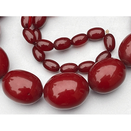 191 - Antique art deco cherry red amber / bakelite bead necklace good internal streaking weight 84g larges... 