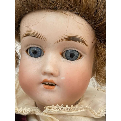 458 - Antique bisque head doll composition body makers mark to back of head height 43cm