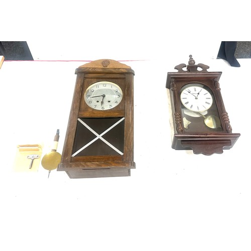263 - Two wooden wall hanging clocks both as found and untested - largest measures approx 22 inches tall b... 