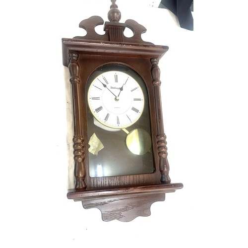 263 - Two wooden wall hanging clocks both as found and untested - largest measures approx 22 inches tall b... 