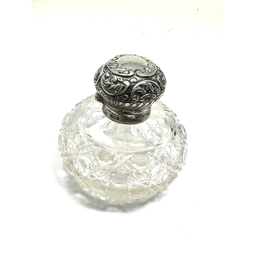 13 - Antique silver & cut glass perfume bottle measures approx height 9cm by 9cm dia London silver hallma... 