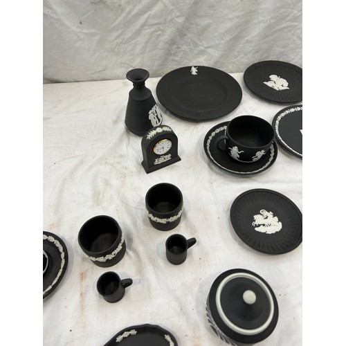 242 - Selection of black and white Wedgwood Jasper ware to include plates, clock, cups etc