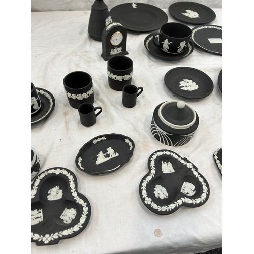 242 - Selection of black and white Wedgwood Jasper ware to include plates, clock, cups etc