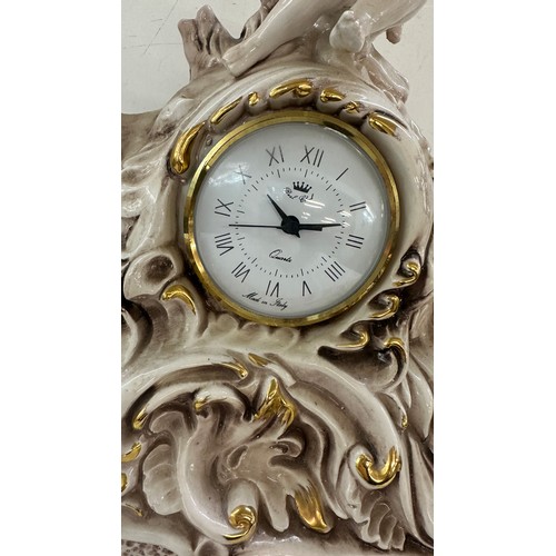 3 - Porcelain mantle clock, depicting cherubs and elephants, untested, approximate measurements: Height ... 