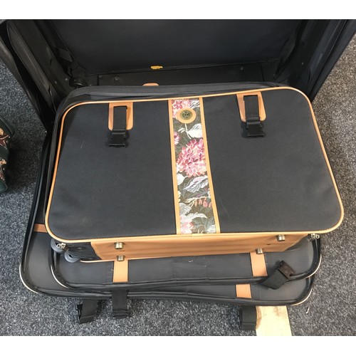 281 - Set of three quality/canvas suitcases and a betty boop suit case