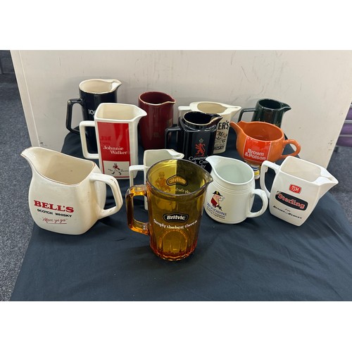 73 - Selection of 12 pub advertising jugs