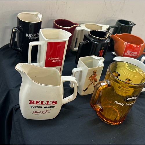 73 - Selection of 12 pub advertising jugs