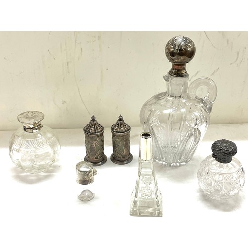 565 - Sterling silver mounted claret jug plus other silver topped bottles