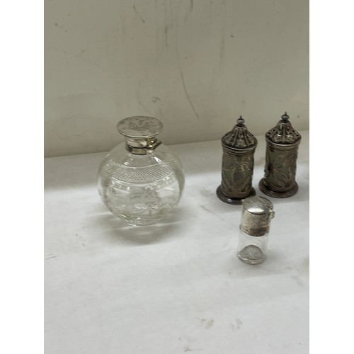 565 - Sterling silver mounted claret jug plus other silver topped bottles