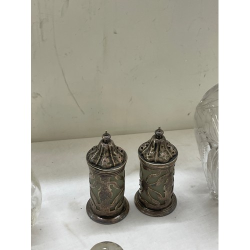 565 - Sterling silver mounted claret jug plus other silver topped bottles