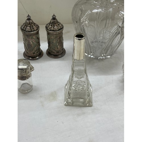 565 - Sterling silver mounted claret jug plus other silver topped bottles