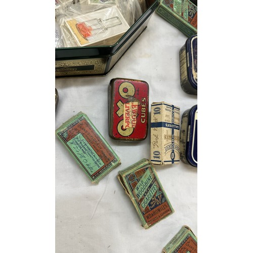 209 - Selection of cigarette card loose as well as an album of cards together with some vintage empty tins