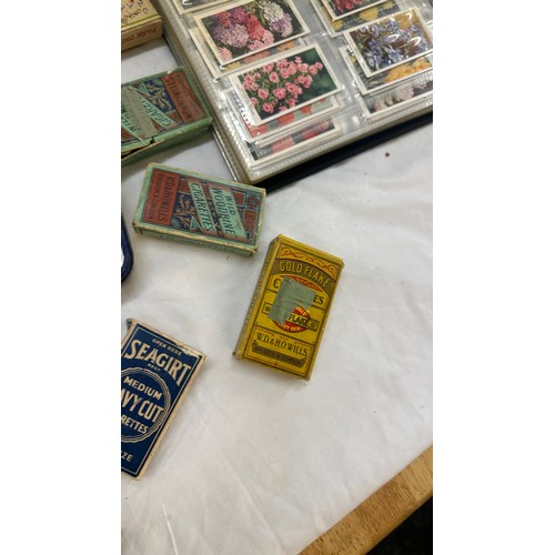 209 - Selection of cigarette card loose as well as an album of cards together with some vintage empty tins