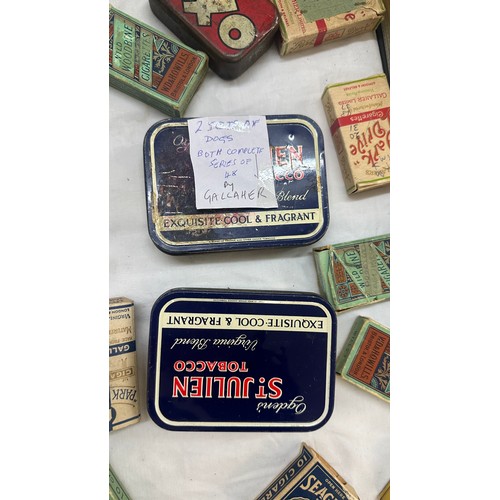 209 - Selection of cigarette card loose as well as an album of cards together with some vintage empty tins