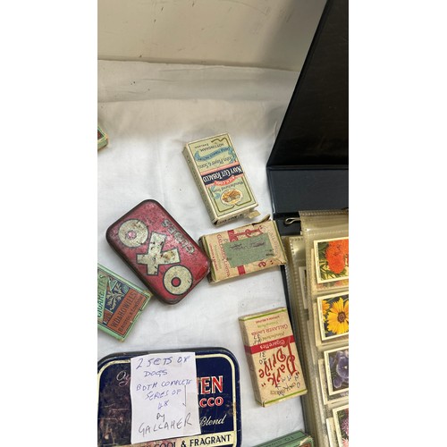 209 - Selection of cigarette card loose as well as an album of cards together with some vintage empty tins