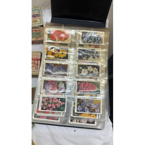 209 - Selection of cigarette card loose as well as an album of cards together with some vintage empty tins